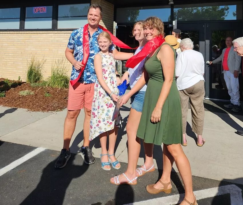 family in front of community space