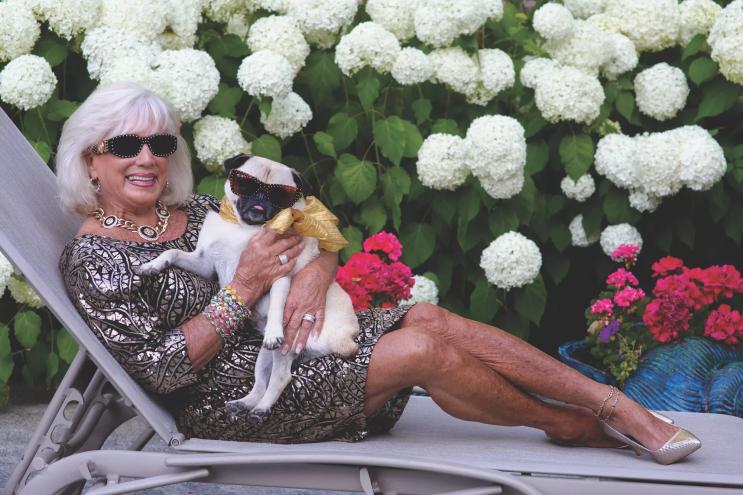 woman with her pug on a chiase lounge