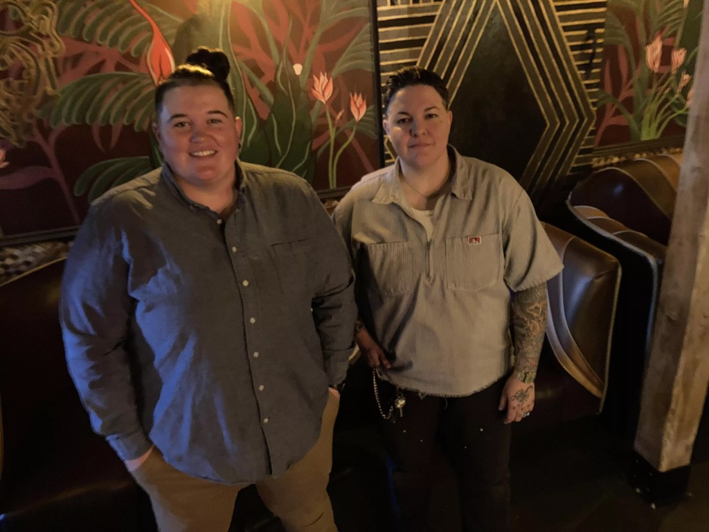 Ashlee Cassity and Dom Garcia standing inside their current bar, Pearl Divers
