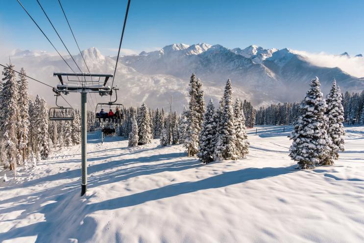 A chairlift at Purgatory Resort backdropped by snowy peaks