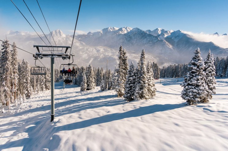 A chairlift at Purgatory Resort backdropped by snowy peaks