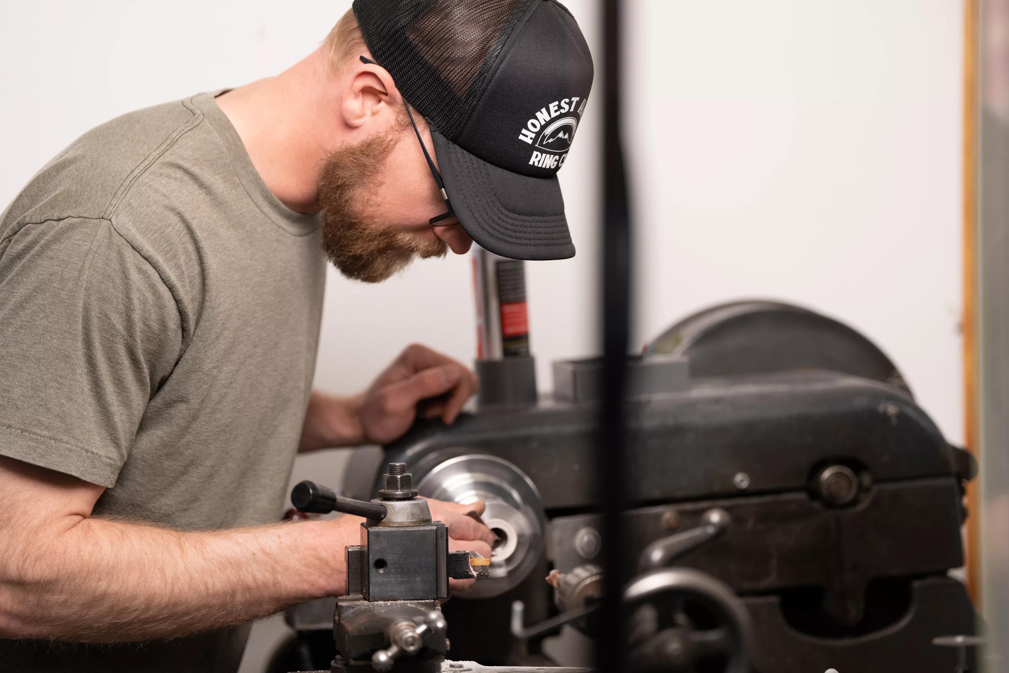 Ben Bosworth working with a machine in his workshop
