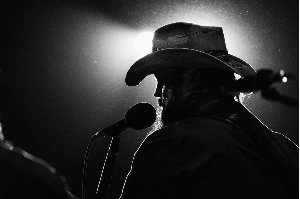 chris stapleton singing at a mic