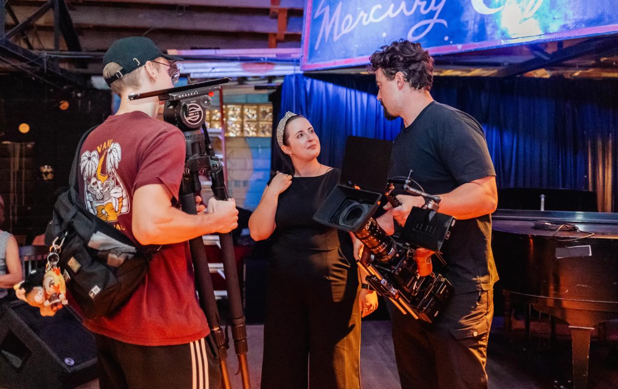 Three filmmakers standing in a room