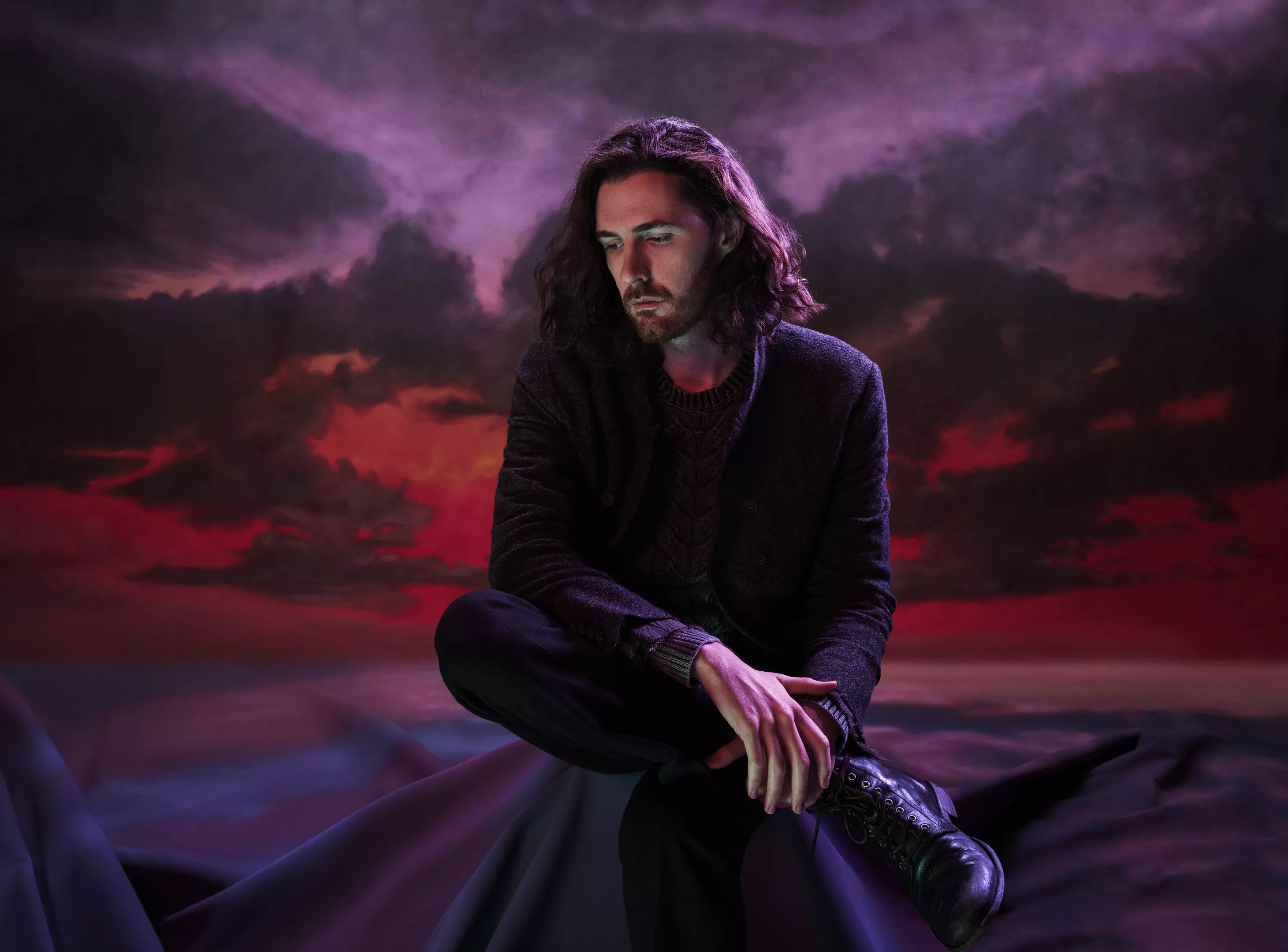 man with long hair looking pensive