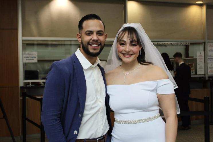 A bride and groom smile