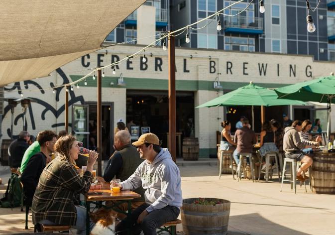 people sitting at tables on a patio