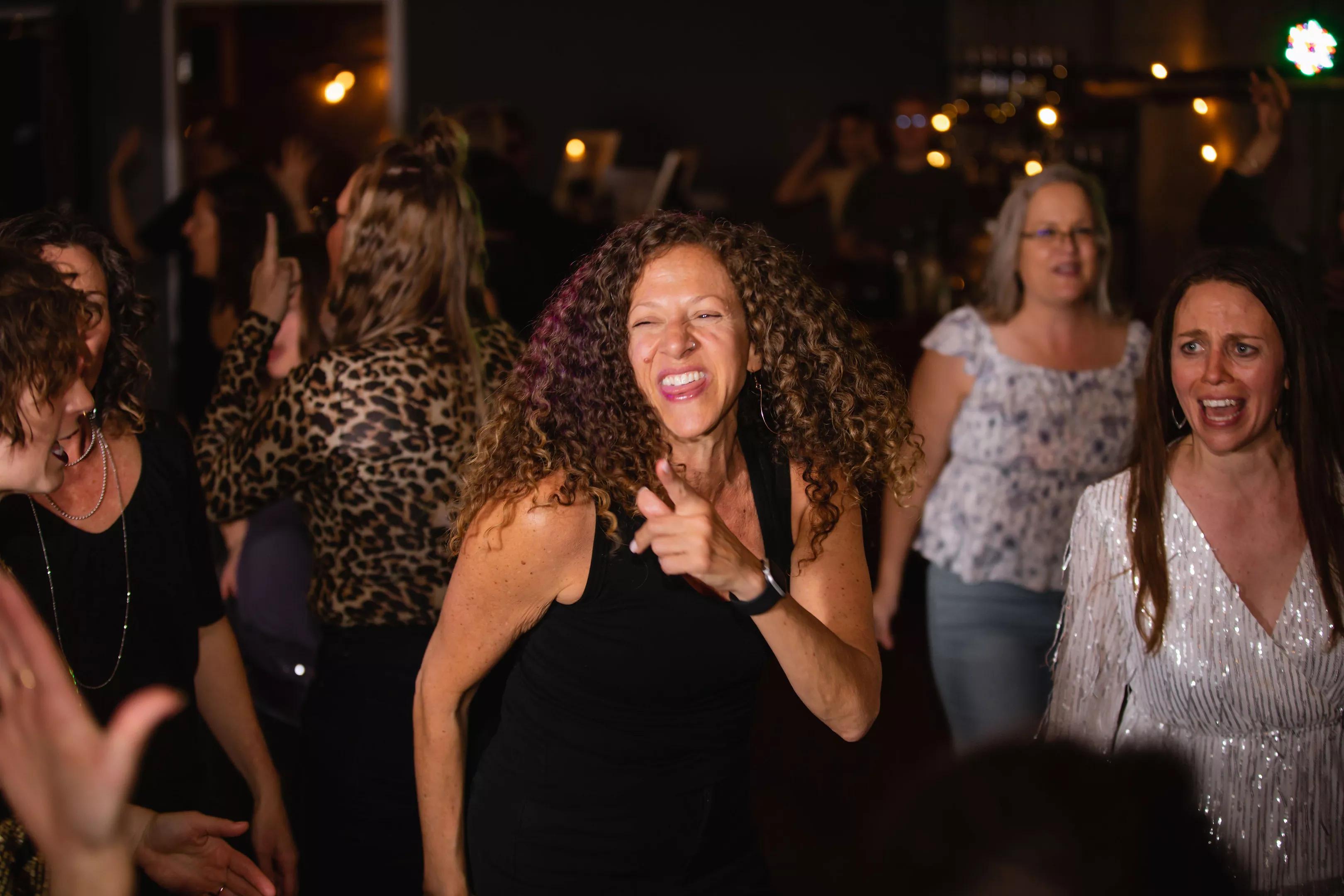 Women dance together.