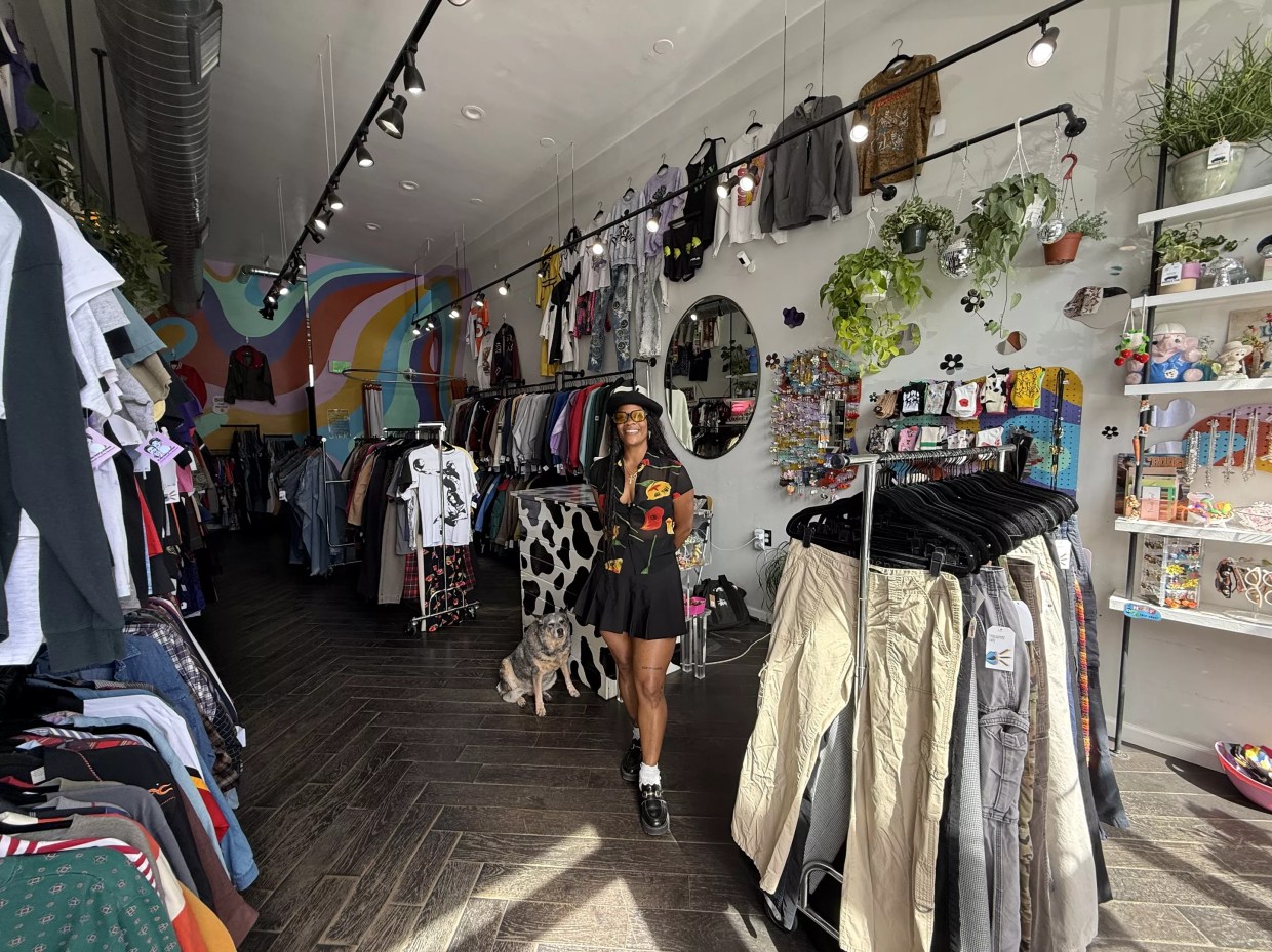 A woman and a dog stand in a vintage shop