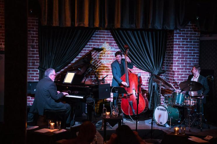 Jazz musicians perform onstage.