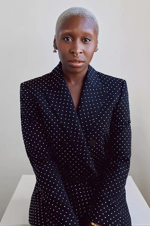 A portrait of a woman in a dark suit