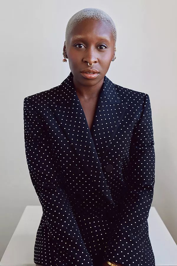 A portrait of a woman in a dark suit