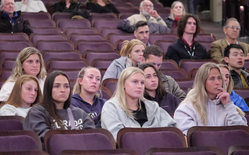 Students listen from the audience