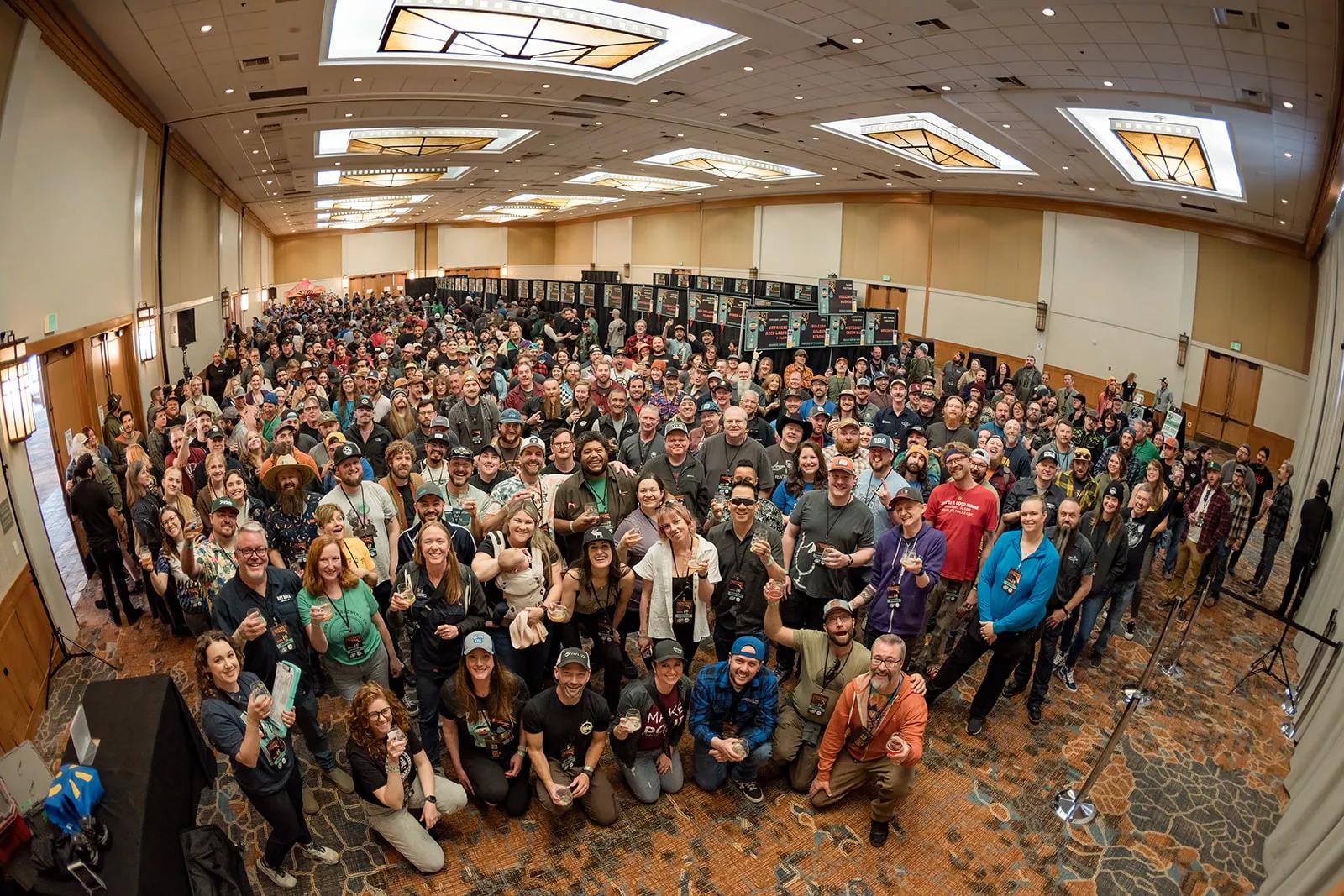 Many beer festival fans in a room.
