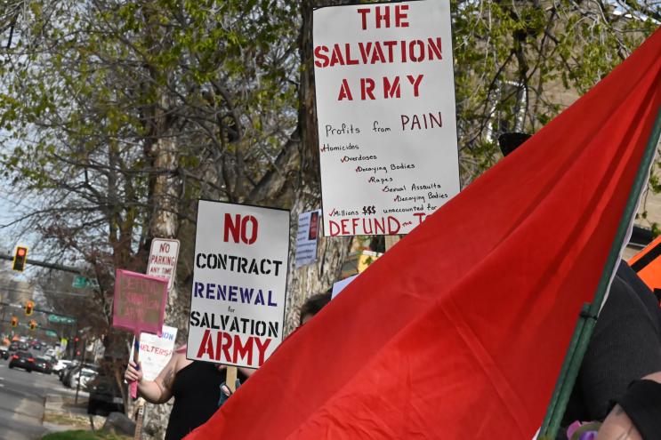 Signs protest the Salvation Army.