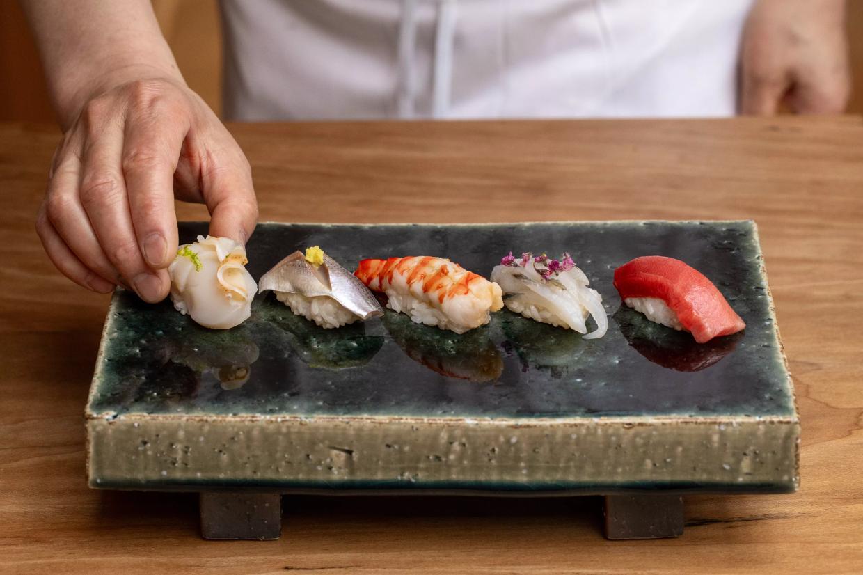 sushi on a black plate