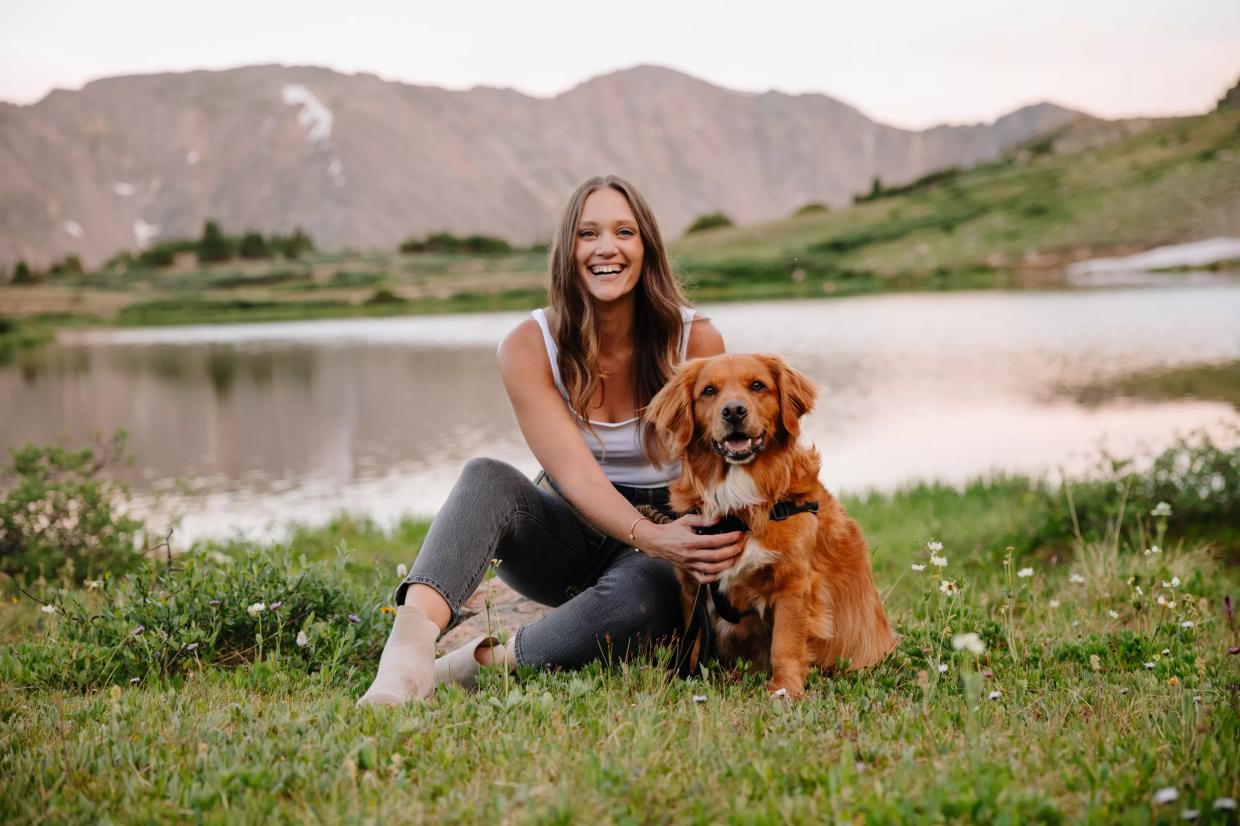 woman sitting with dog outside