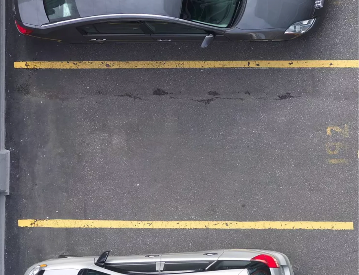 empty parking spot between two parked cars
