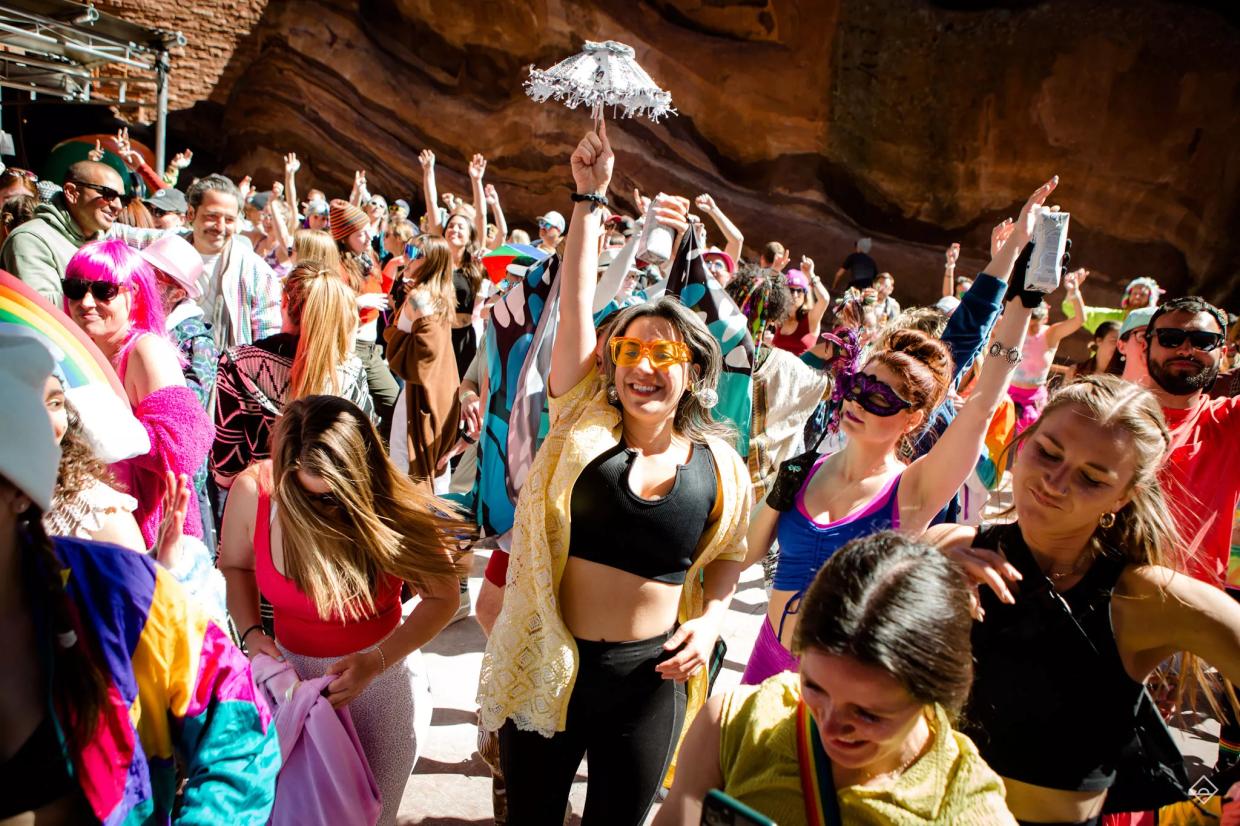 People dance at Red Rocks.