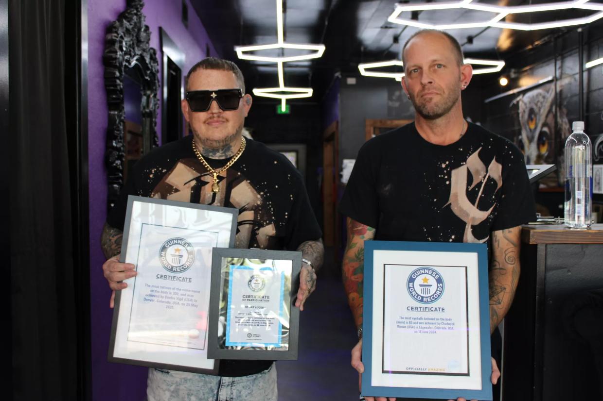 Two men hold plaques.