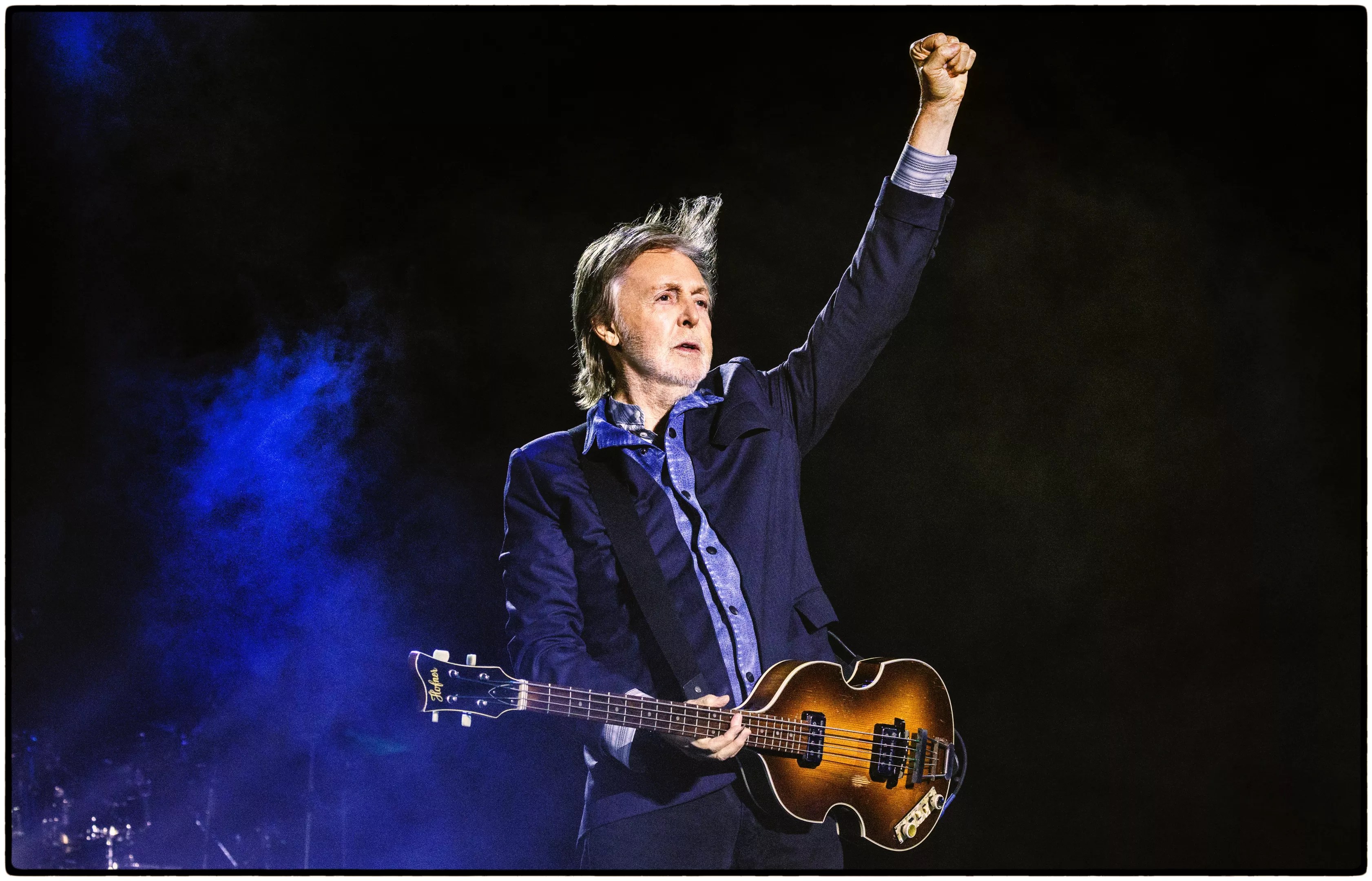 Paul McCartney with a guitar on stage