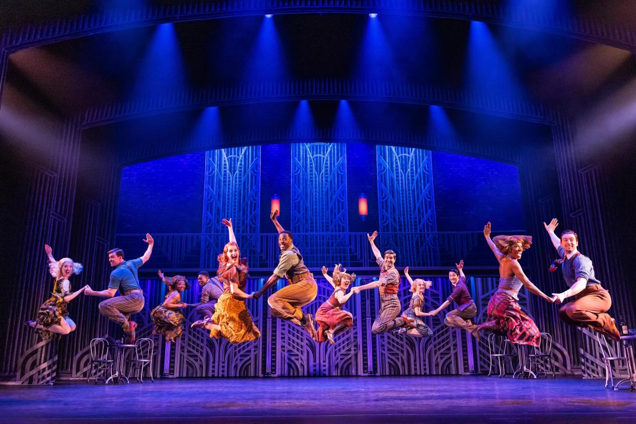 A musical theater ensemble performs a musical number.