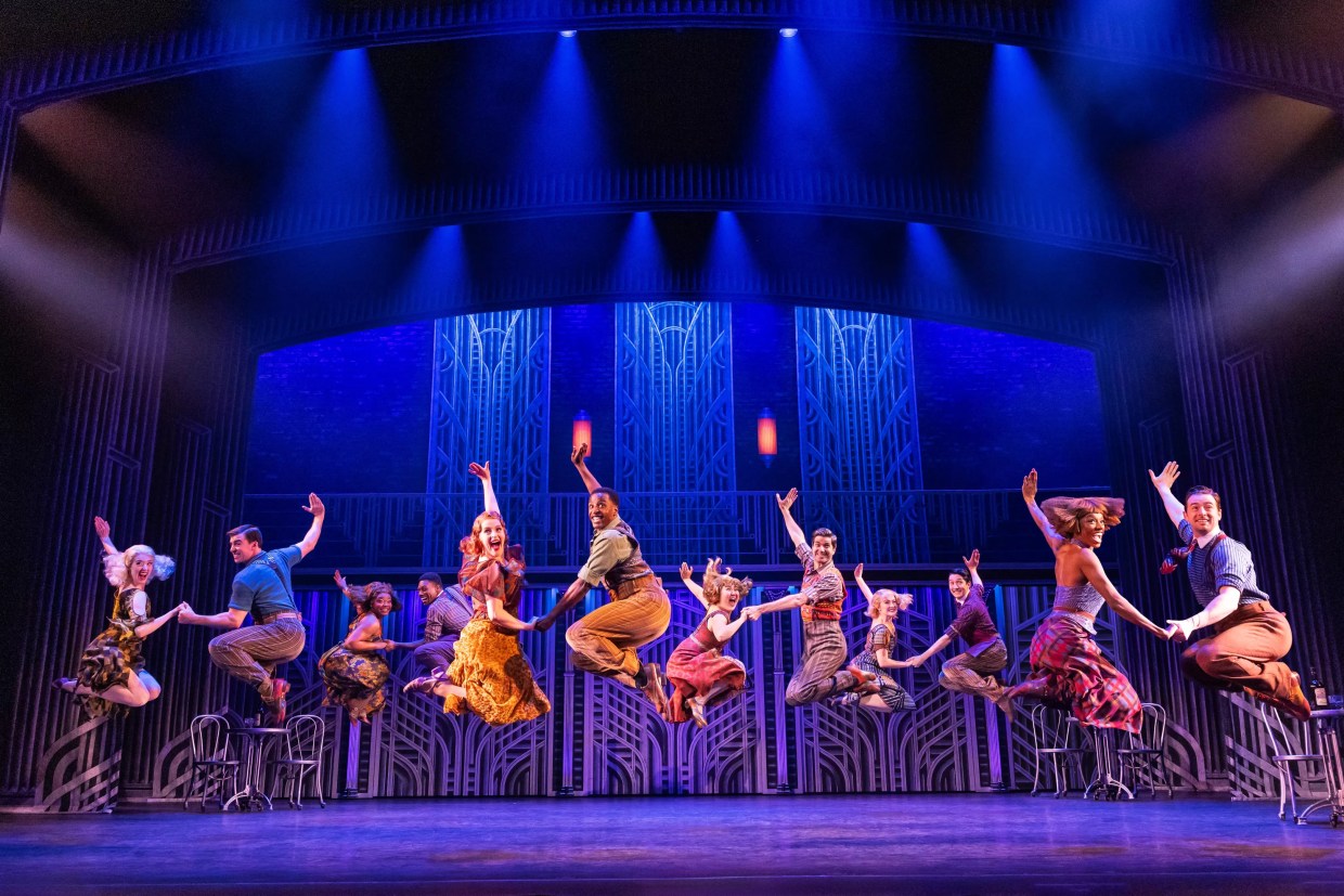 A musical theater ensemble performs a musical number.