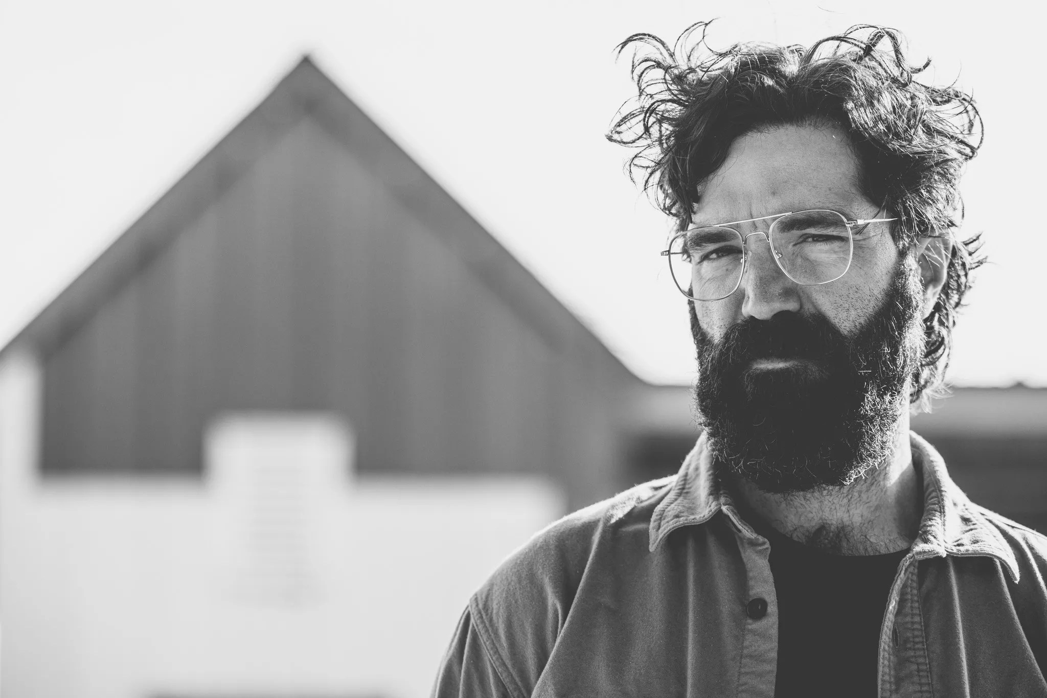 man with glasses outside a pyramid