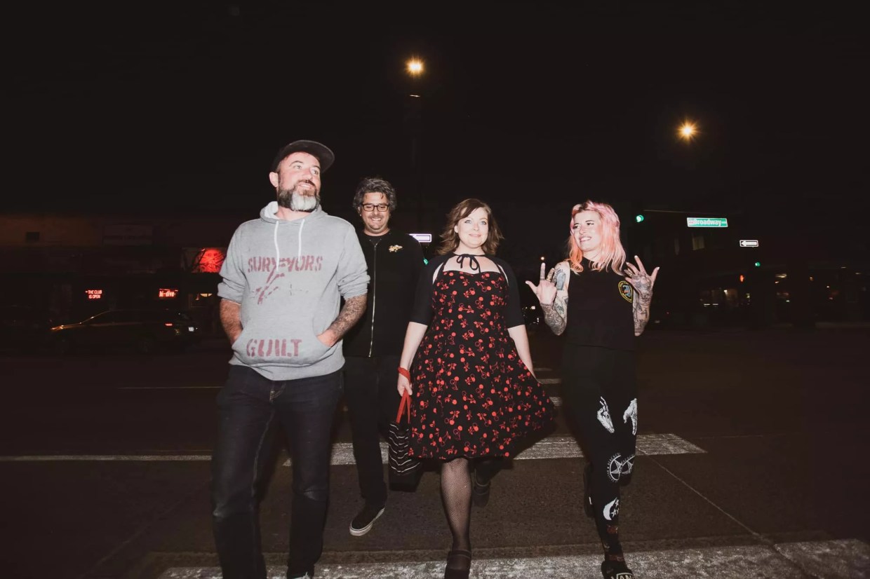 Four people standing in a line