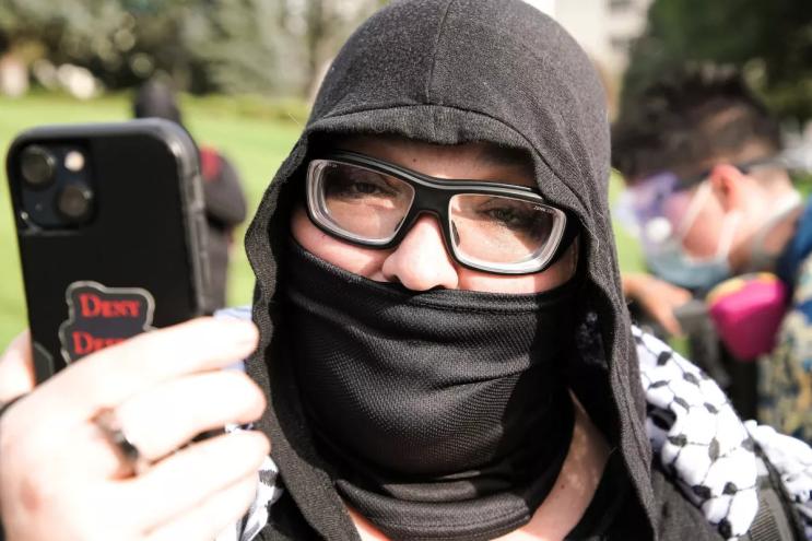 A woman yells towards a camera.