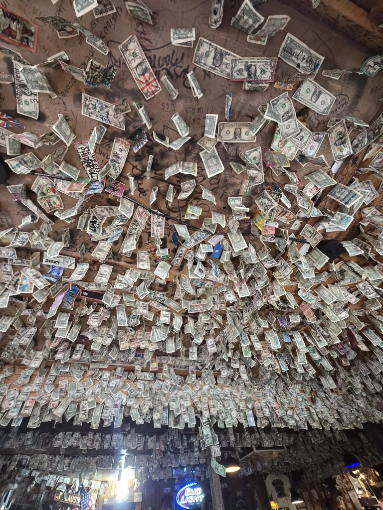 dollar bills hanging from a ceiling