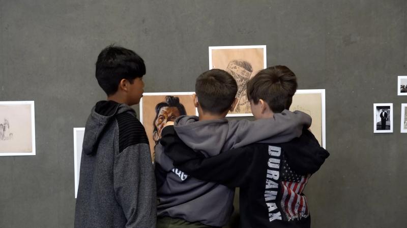Kids gather around art.